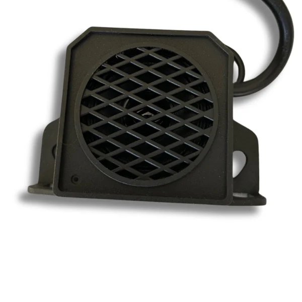 Compact black reversing alarm unit for vans and motorhomes with protective grille and mounting bracket.